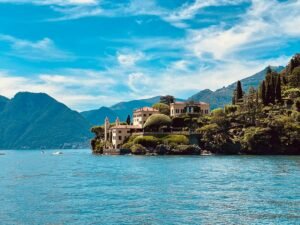 Lake Como, Italy. A building mansion perched on the edge of an outcrop in a beautiful lake setting