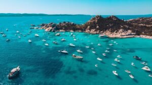 Sardinia, Italy. Tranquil turquoise bay with numerous pleasure boats spread evenly