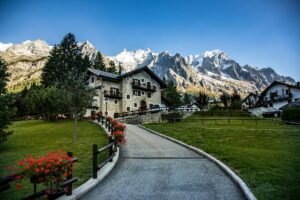 Courmayeur, Valle D'Aosta, Italy. Chalet in the foreground of a snow covered Italian Alps