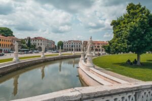 Padova, Padua, Italy. A town park with monuments and statues along a man-made canal in a perfect semi-circle.